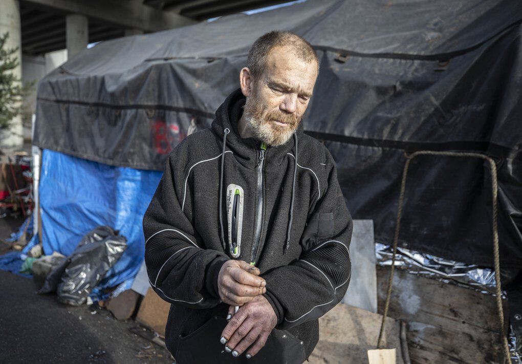 Dean Williamson had been tested multiple times at a homeless encampment in Seattle but had not contracted COVID-19. He has many doubts about the upcoming vaccine.    (Steve Ringman / The Seattle Times)